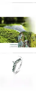 Macro detail of V-shaped S925 silver ring with green moss agate stone inlay