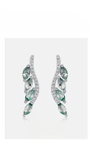 Detailed view of wave-shaped S925 silver earrings with green moss agate and zircons