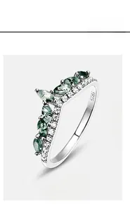 Macro detail of V-shaped S925 sterling silver ring with green moss agate and zircons