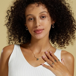 Close-up of S925 silver green moss agate necklace and earrings set on elegant female model