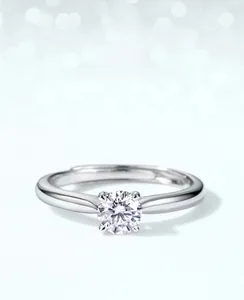 Close-up of sparkling moissanite diamond ring featuring a classic four-prong silver setting