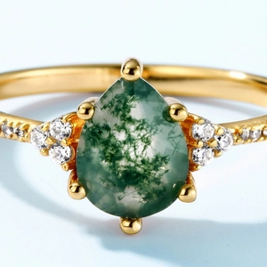 Pear shape moss agate ring in gold finish with sparkling side stones and green inclusions