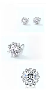 Detailed macro view of S925 sterling silver snowflake earrings with heart-shaped claw settings