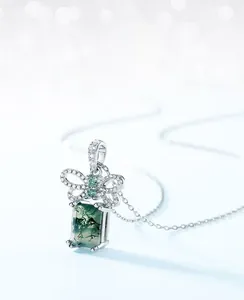 Macro shot of rectangular moss agate pendant with silver butterfly clasp detail