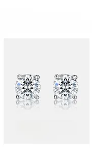 Macro detail of classic four-prong moissanite stud earrings in polished silver setting