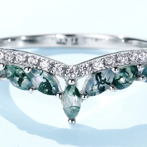 S925 silver crown ring with marquise moss agate and zircon stones on a blue background