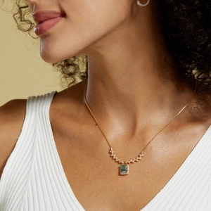 Detail of square moss agate pendant necklace with branch diamond accents on gold chain