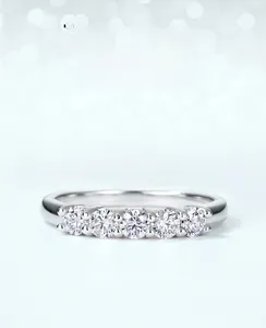 Detail of five moissanite stones in a row with brilliant cut and hollow base design
