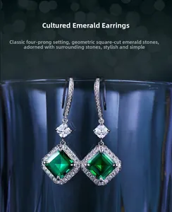 Detailed view of square-cut emerald earrings with classic four-prong setting and pavé accents
