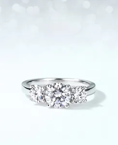 Macro view of three-stone S925 moissanite ring with round brilliant cut and silver finish