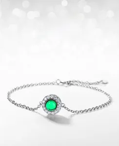 Detail of lab-grown emerald bracelet with round cabochon stone and silver chain