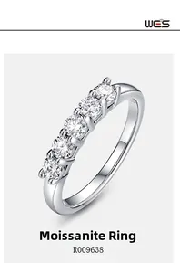Macro shot of silver ring with five round moissanite stones in a row setting