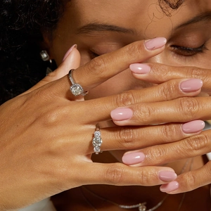 Close-up of S925 sterling silver moissanite rings on model hands for proposal