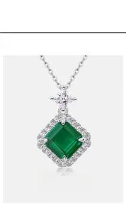 Macro view of square emerald pendant featuring a halo setting of sparkling white zircons