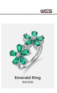 Macro view of flower shaped S925 silver ring with pear cut emeralds and stones RG018295