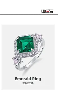 Detail of square emerald cut ring with micro-pave diamonds and pink side stones