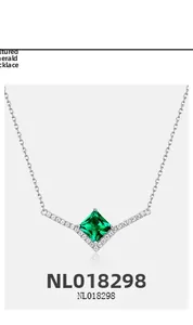 Detailed view of S925 silver V-shaped necklace with princess cut emerald and diamonds