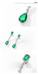 Macro detail of S925 silver emerald drop earrings with pear-cut green gemstones