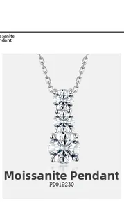 Detailed macro view of triple round-cut moissanite stones in a vertical S925 silver pendant