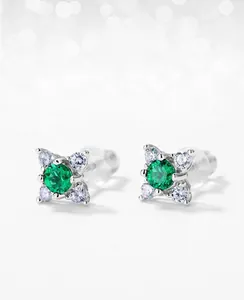 Macro view of S925 silver stud earring with lab emerald and small zircon accents