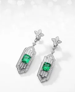 Macro detail of emerald-cut lab-grown earrings featuring a vintage silver zircon halo setting