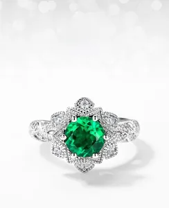 Macro detail of lab-grown emerald ring with snowflake halo setting in S925 silver