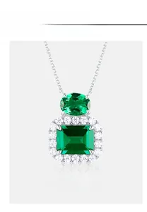 Detailed view of emerald-cut gemstone necklace with diamond halo on silver chain