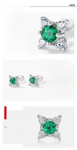Macro view of S925 silver petal-shaped stud earrings with green emerald stones