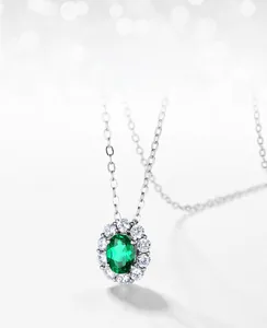 Macro shot of S925 silver pendant with oval lab-grown emerald and zircon halo setting