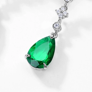 Luxurious S925 silver pear-cut emerald drop earrings with sparkling white gemstones