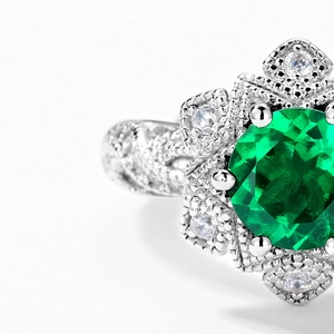 Vintage S925 silver ring featuring a large emerald-cut green stone with floral diamond halo
