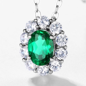 Vintage S925 silver necklace featuring an oval emerald pendant with a sparkling halo