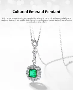 Macro shot of rectangular lab-grown emerald pendant with white zircon halo on silver chain
