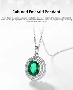 Macro detail of oval lab-grown emerald pendant with sparkling zircon halo setting