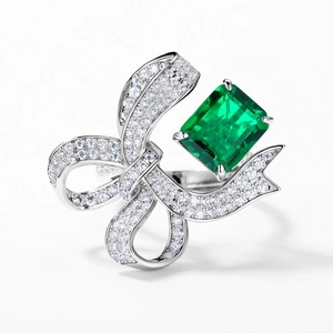 Elegant S925 silver ring featuring emerald-cut green stone and pavé bow design