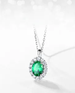 Macro shot of S925 silver pendant with lab-grown emerald and sparkling zircon halo
