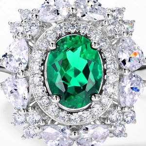 Luxurious S925 silver ring featuring an oval emerald stone with floral halo design