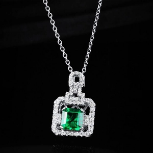 Emerald cut green gemstone pendant necklace with halo of white zircons on O-chain