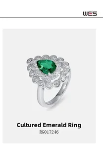 Macro detail of pear-cut lab emerald ring with halo setting in S925 silver metal