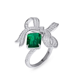S925 silver ring featuring emerald cut green stone and diamond bow setting on white background