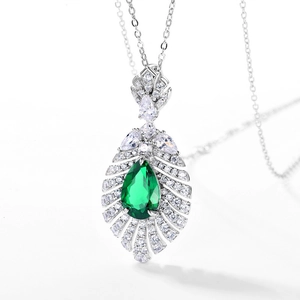 Vintage S925 silver necklace featuring a pear-cut emerald pendant with halo diamonds