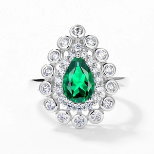 Vintage S925 silver ring featuring a pear-cut emerald gemstone with a double halo design