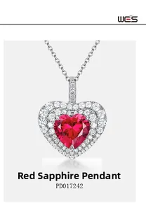 Detailed close-up of heart-shaped red corundum pendant with double halo diamond setting
