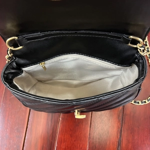 Sac à chaîne noir matelassé avec compartiments intérieurs et détails en métal doré