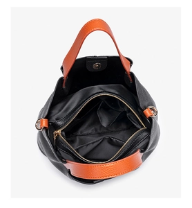 Internal view of a leather briefcase showing multi-pocket compartments and magnetic snap