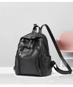 Detail view of black lychee texture leather backpack with front zipper and side pocket