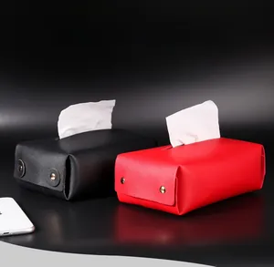 Detail showing red and black faux leather tissue boxes with textured finish and metal snap