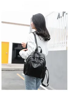 Outdoor model show of a black high-capacity PU leather backpack with multi-zipper layers