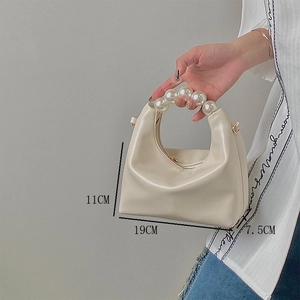 Detail view of mini cream pearl handle bag showing 11x19x7.5cm dimensions and chain strap