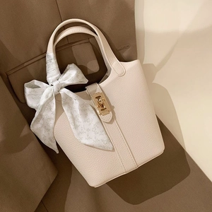 Cream lychee leather bucket bag with floral silk scarf and gold metal lock closure